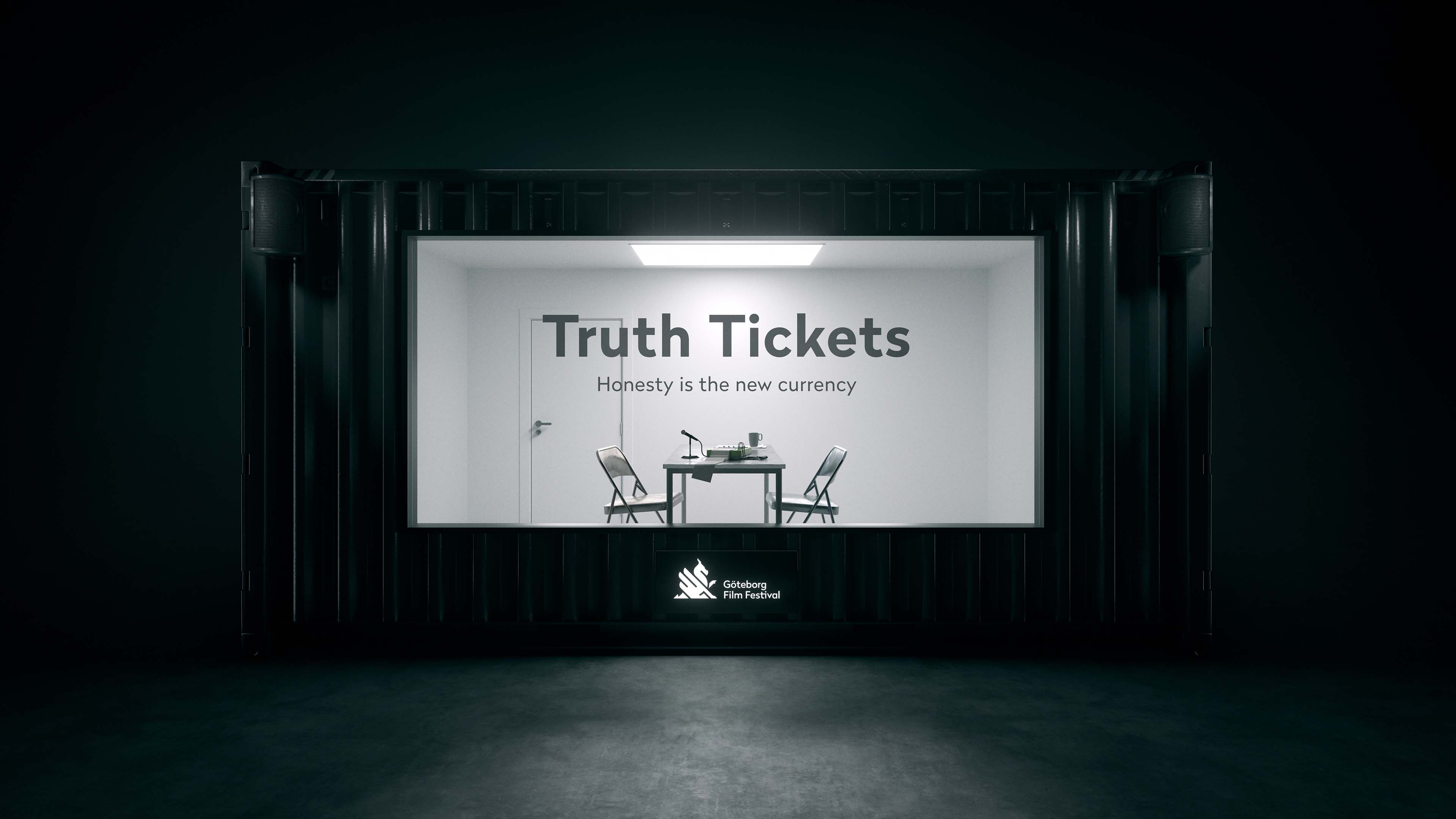 Minimalist interrogation room with two chairs and a table under a light, text on the wall says 'Truth Tickets Honesty is the new currency,' and Göteborg Film Festival logo below.