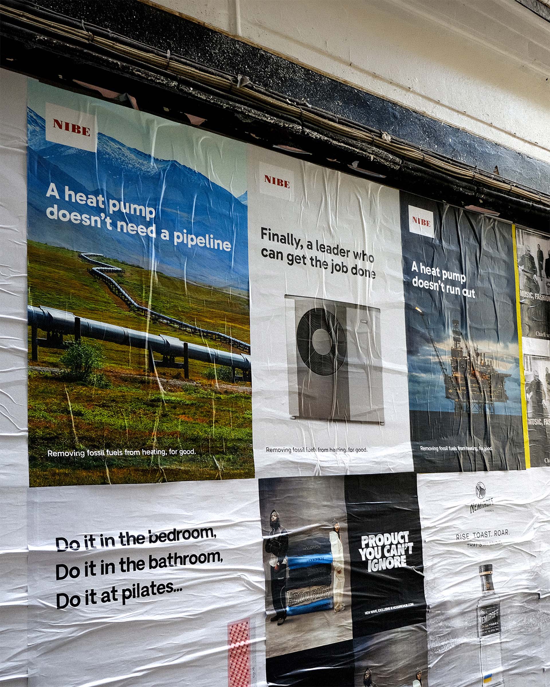 Wall posters showing NIBE ads about heat pumps removing fossil fuels.